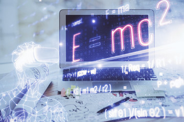 Desktop computer background and formula hologram writing. Double exposure. Education concept.