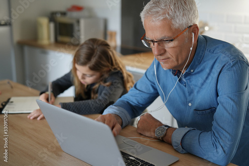Cuadros en Lienzo Father and school-girl working form home, telework and e-learning