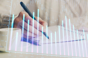 Forex chart displayed on woman's hand taking notes background. Concept of research. Double exposure