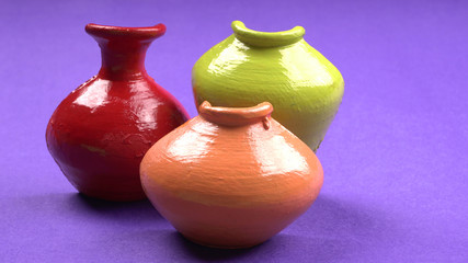 Beautiful empty decorative ceramic pots in warm happy colors on colorful background.