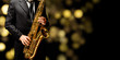 Playin' sax isolated at the left border of a black background