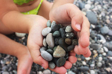 Heart Shaped Small Pebbles In Children's Hands