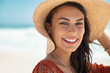 Leinwandbild Motiv Beautiful girl with straw hat at beach