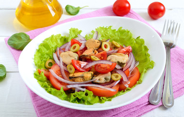 Wall Mural - Salad of marinated mussels, fresh tomatoes, red onions, olives in a bowl on a white wooden background