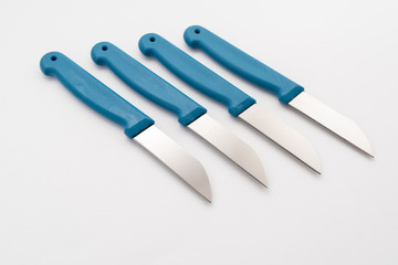 Wall Mural - four sharp knives with blue plastic handle on white background