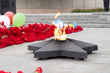 Eternal Flame In The Shape Of A Star Burns In Memory Of Those Killed In The Second World War Among Fresh Floral Tribute.