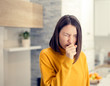 Ill woman with flu virus caughing sneezing indoors at home