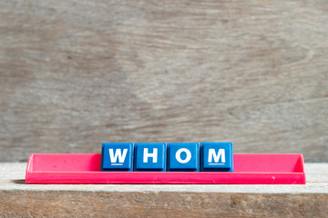 Sticker - Tile letter on red rack in word whom on wood background