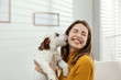 © New Africa - Young woman with her cute Jack Russell Terrier at home. Lovely pet