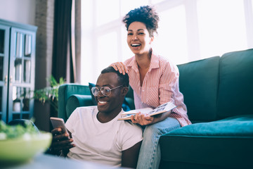 Wall Mural - Laughing couple enjoying time together in apartment