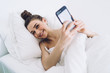 © BullRun - Tranquil woman waking up and taking selfie in domicile