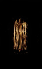 Luminous thread of a retro Edison lamp on a dark background