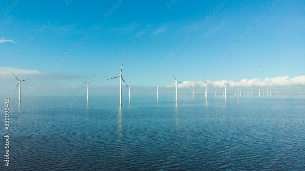 Windmill row of windmills in the ocean by the lake Ijsselmeer Netherlands, renewable energy windmill farm Flevoland - obrazy, fototapety, plakaty 