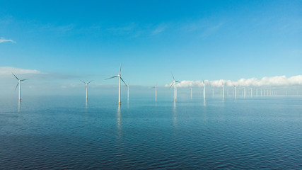 Wall Mural - Windmill row of windmills in the ocean by the lake Ijsselmeer Netherlands, renewable energy windmill farm Flevoland