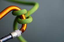 Green Rope Wrapped Around Orange Carabiner