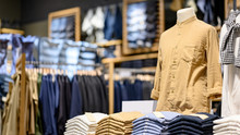 Trendy Cotton Men Shirt Display On Mannequin In Clothes Shop. Summer Collection Fashion Product Samples In Clothing Store For Selling. Textile Industry And Business Concept