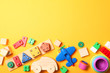 © White bear studio  - Set of different children's toys on a colored background top view. A place to insert text, minimalism. Baby background.