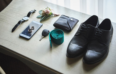 different accessories of a businessman for creating a style of a people lie on a wooden background