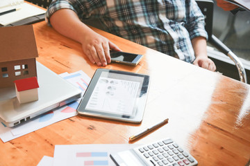 businessman hands searching for data on Notebook with analyzing charts at his workplace.