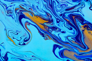 Wall Mural - Fluid art texture. Abstract backdrop with swirling paint effect. Liquid acrylic artwork with trendy mixed paints. Can be used for website background. Blue, golden and cyan overflowing colors