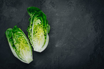 Wall Mural - Fresh Green Romaine Lettuce for Caesar Salad on dark stone background.