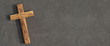 © OFC Pictures - Holzkreuz liegt auf dunkler Steinplatte