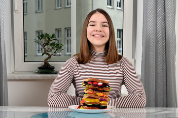 Wall Mural - happy teenage girl with vegetarian sandwich at home