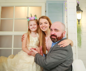 Wall Mural - Happy young family with daughter have fun together at home in yard