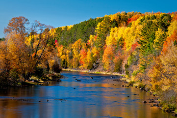 Wall Mural - Vivid autumn colors reflected in the Paint River at Crystal Falls, Michigan.