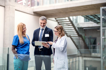 group of doctors talking to pharmaceutical sales representative.