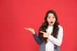 © be free - Recommend this product. Happy child present product on red background. Little girl pointing fingers at copy space. Promotion and presentation. Product advertising. Promoting product or service