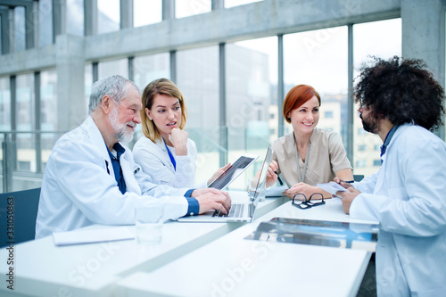 Cuadros en Lienzo Group of doctors with laptop on conference, medical team discussing issues
