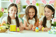 © aletia2011 - Cute girls wearing rabbit ears decorating Easter eggs