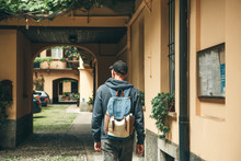A Tourist Or Traveler With A Backpack Is Looking For Accommodation That He Has Booked Or A Student Returned Home After Studying Or On Vacation.