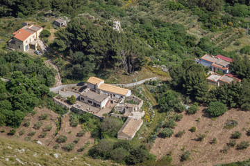 Wall Mural - Residential buildings on a slope of Erice Mountain seen from Erice town, Sicily Island in Italy