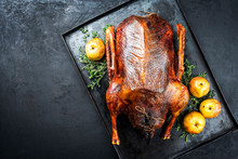 Traditional Roasted Stuffed Christmas Goose With Apples And Herbs As Top View On A Rustic Metal Tray With Copy Space Left