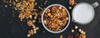 a delicious and crunchy oatmeal granola with honey, nuts, dried fruits and grains is poured out of the praml package into a plate.  food photography background