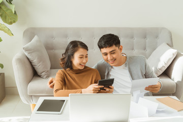 Young Asian man and woman stress with her business online shopping at office.