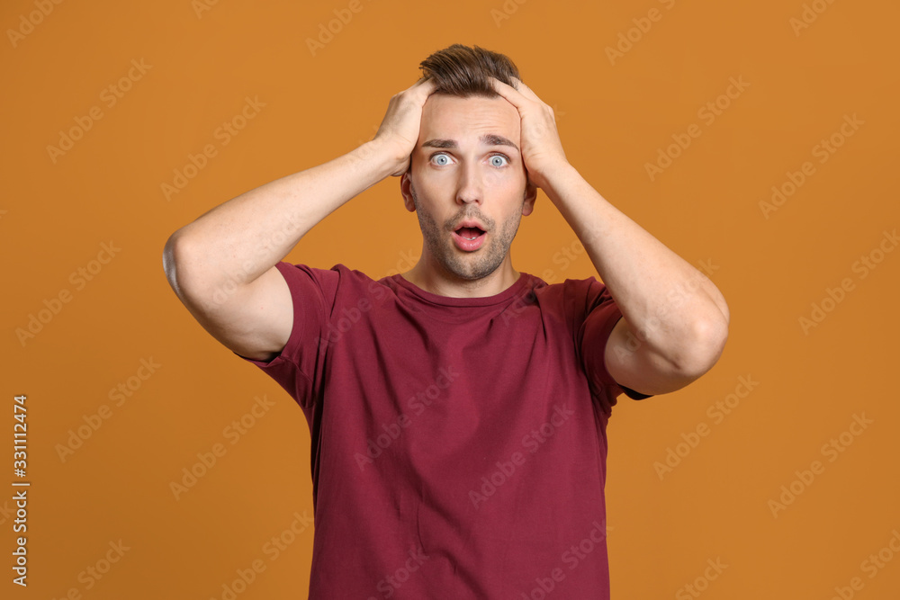 Shocked man on color background