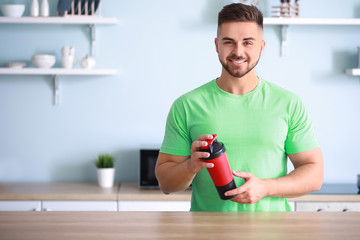 Sticker - Sporty man with protein shake in kitchen