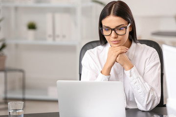 Poster - Beautiful young businesswoman working in office