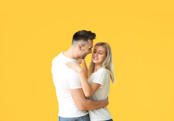 Poster - Happy dancing young couple on color background