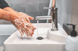 © Maridav - Washing hands with soap and warm water for 20 seconds for corona virus COVID-10 prevention. Work man for corona virus hygiene to stop spreading coronavirus.