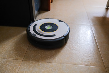 Sweeping robot working on floor at home