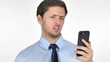 © stockbakers - Young Businessman Reacting to Loss on Smartphone on White Background