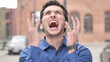 © stockbakers - Outdoor Standing Angry Young Man Screaming in Frustration