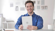 © stockbakers - Online Video Chat on Tablet by Businessman