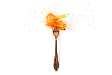 Italian pasta design. A vintage fork with penne and smoked salmon, sprinkled with ground black pepper, shot from the top on a white background with a place for text