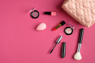 Wall Mural - Makeup bag with cosmetic beauty products on pink background. Top view, flat lay. Beauty and fashion concept.