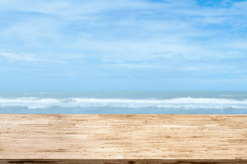 Wall Mural - light brown wood table on blurred seascape background